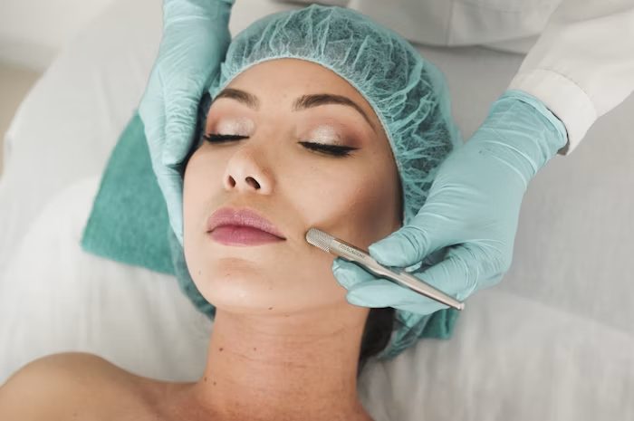 A clinician performing a device treatment on a patient's face