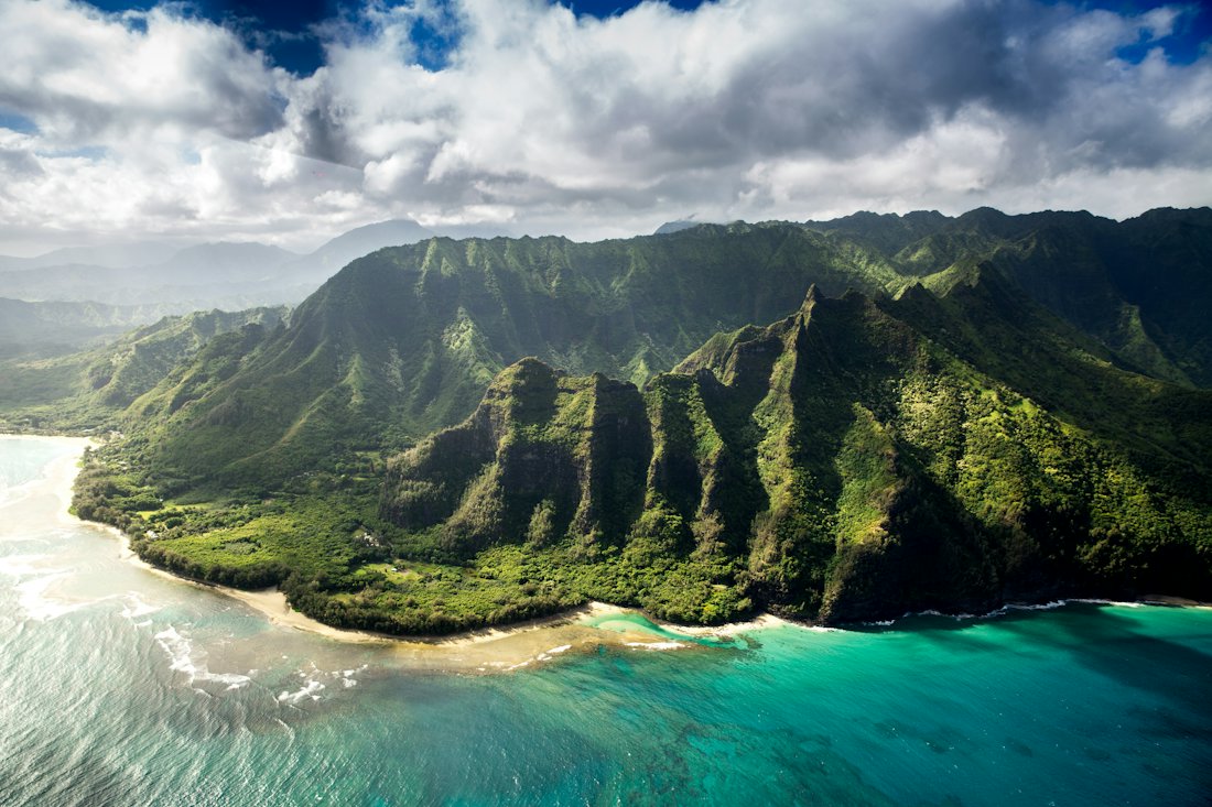 Green coastal mountains meeting the ocean